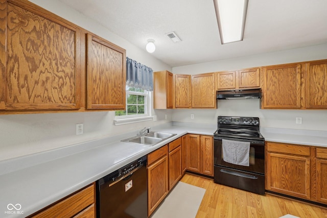 764 Port Dr, Avon, IN 46123 - kitchen featuring black appliances, under cabinet range hood, a sink, light wood-type flooring, and light countertops