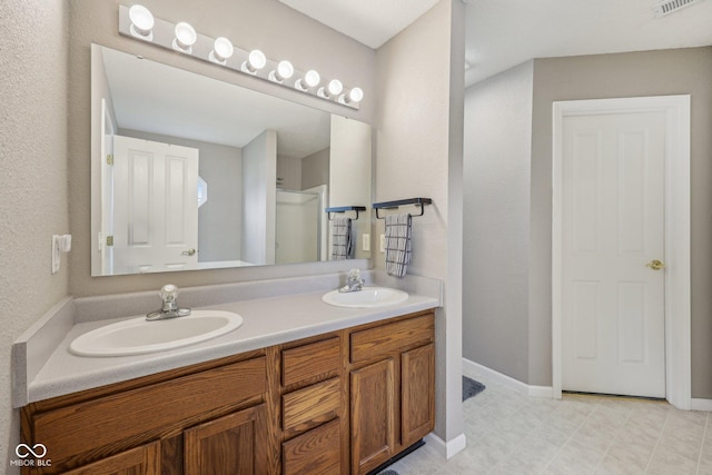 764 Port Dr, Avon, IN 46123 - full bathroom featuring double vanity, baseboards, and a shower