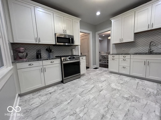 4040 Carrollton Ave, Indianapolis, IN 46205 - kitchen with stainless steel appliances, a sink, tasteful backsplash, baseboards, and recessed lighting