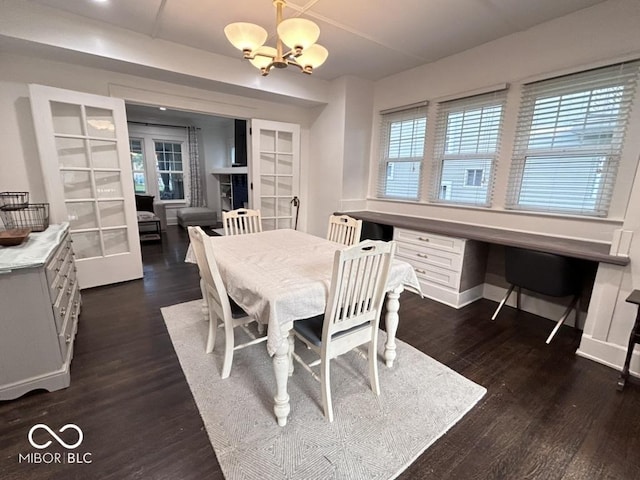 4040 Carrollton Ave, Indianapolis, IN 46205 - dining space with a chandelier, dark wood-style floors, baseboards, and french doors