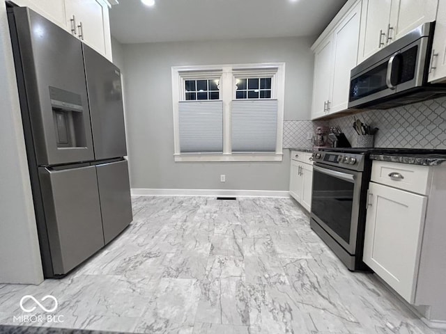 4040 Carrollton Ave, Indianapolis, IN 46205 - kitchen featuring stainless steel appliances, white cabinetry, backsplash, and light marble finish flooring