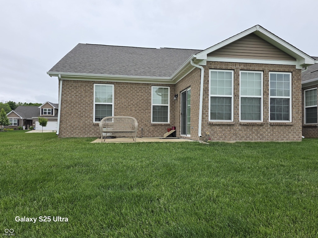 9106 Hedley Way E, Avon, IN 46123 - view of front of house featuring brick siding, a front yard, and a shingled roof