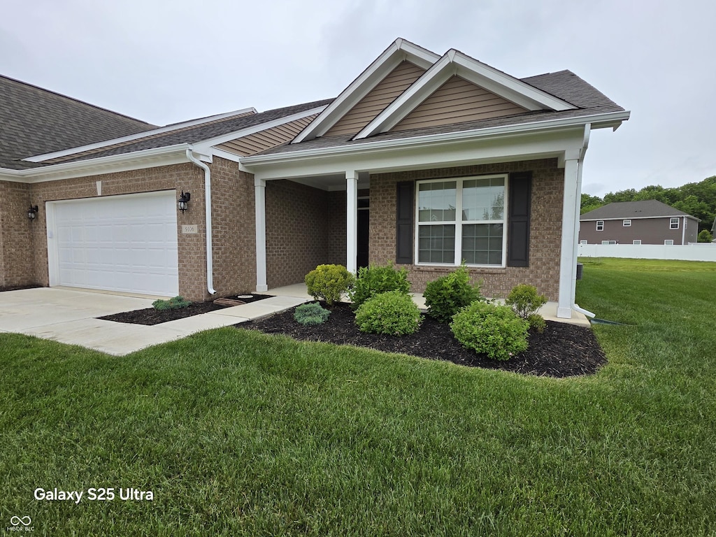 9106 Hedley Way E, Avon, IN 46123 - view of front of property with an attached garage, brick siding, driveway, and roof with shingles