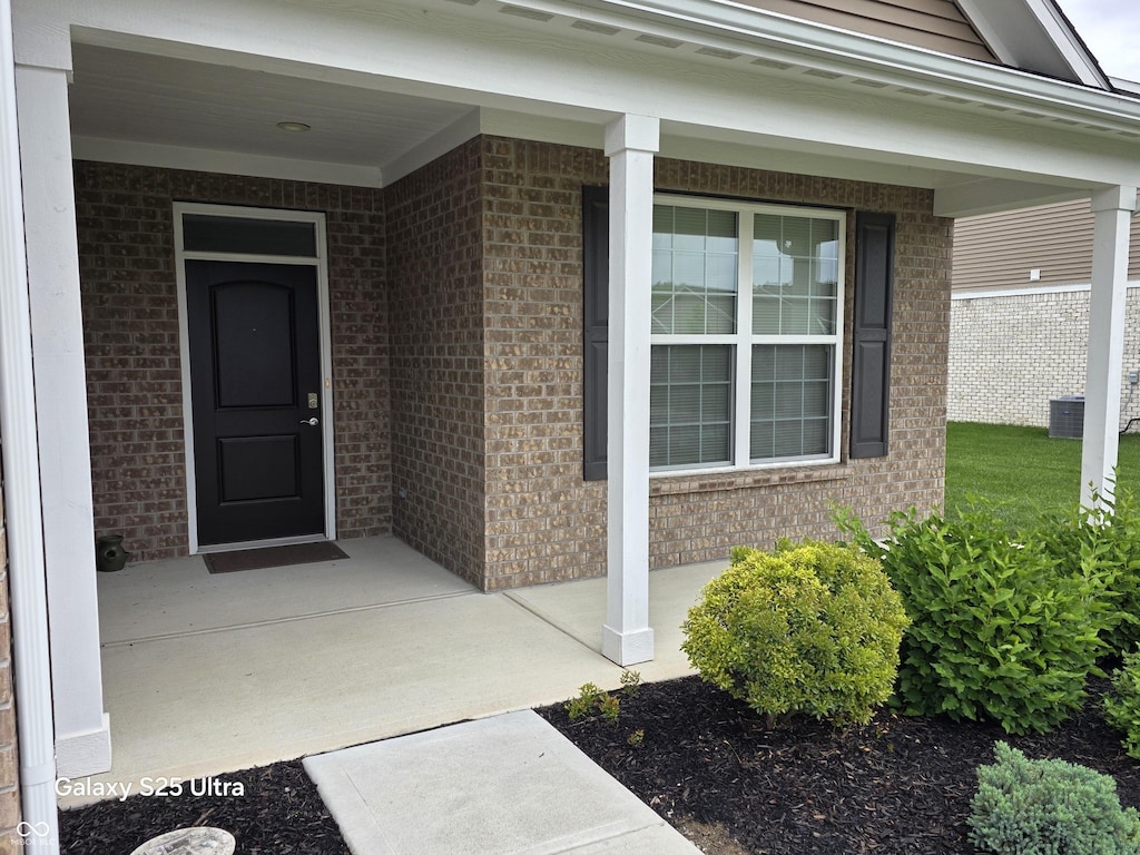9106 Hedley Way E, Avon, IN 46123 - property entrance with brick siding, a porch, and cooling unit