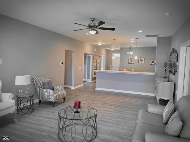 9106 Hedley Way E, Avon, IN 46123 - living area featuring wood finished floors, baseboards, recessed lighting, and a ceiling fan