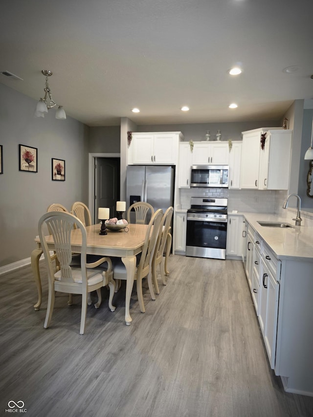 9106 Hedley Way E, Avon, IN 46123 - dining room with light wood-style floors, baseboards, and recessed lighting