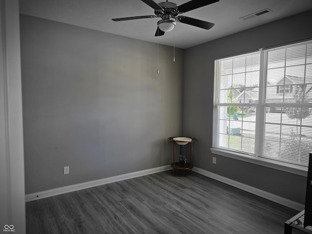 9106 Hedley Way E, Avon, IN 46123 - empty room with dark wood-style floors, a ceiling fan, and baseboards