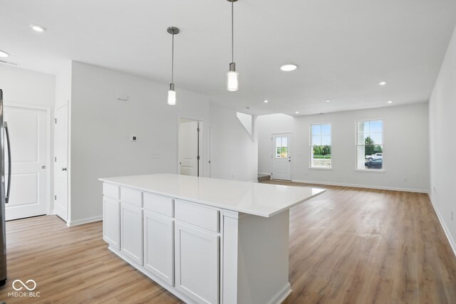 3947 Wren Dr, Brownsburg, IN 46112 - kitchen featuring light wood-style floors, white cabinetry, pendant lighting, recessed lighting, and a kitchen island