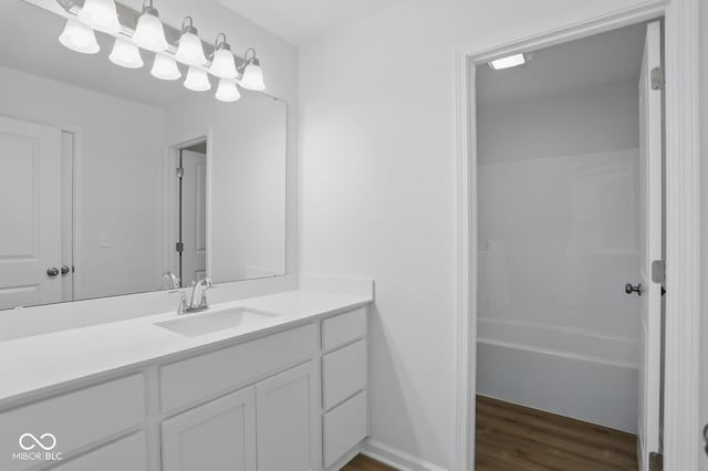 3947 Wren Dr, Brownsburg, IN 46112 - bathroom with vanity, wood finished floors, and washtub / shower combination