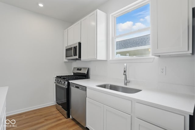 3947 Wren Dr, Brownsburg, IN 46112 - kitchen featuring a sink, appliances with stainless steel finishes, white cabinetry, and recessed lighting