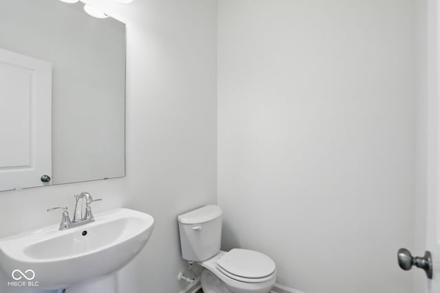 3947 Wren Dr, Brownsburg, IN 46112 - half bathroom with a sink, baseboards, and toilet