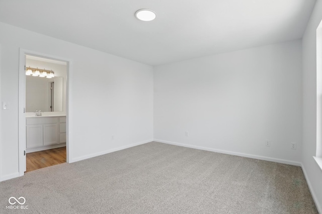 3947 Wren Dr, Brownsburg, IN 46112 - unfurnished bedroom featuring carpet floors, baseboards, connected bathroom, and a sink