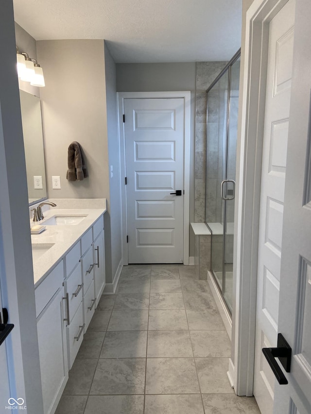 8876 Boylan Pl, Pendleton, IN 46064 - full bath featuring double vanity, a shower stall, tile patterned flooring, and baseboards