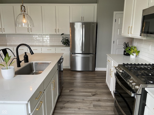 8876 Boylan Pl, Pendleton, IN 46064 - kitchen featuring appliances with stainless steel finishes, a sink, white cabinetry, and dark wood-style floors