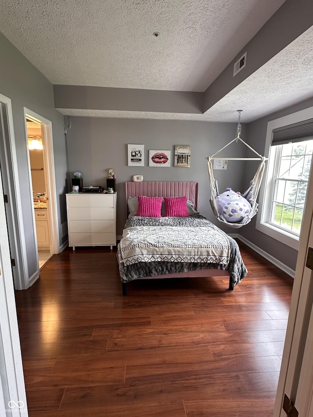 7601 Newport Bay Dr Unit 203, Indianapolis, IN 46240 - bedroom featuring a textured ceiling, wood finished floors, and baseboards