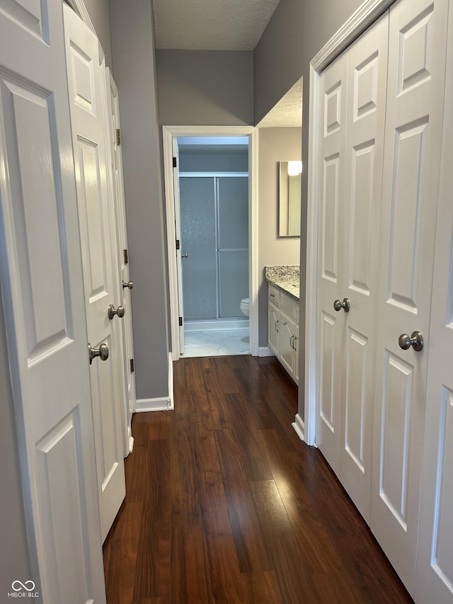 7601 Newport Bay Dr Unit 203, Indianapolis, IN 46240 - hall featuring dark wood-type flooring and baseboards
