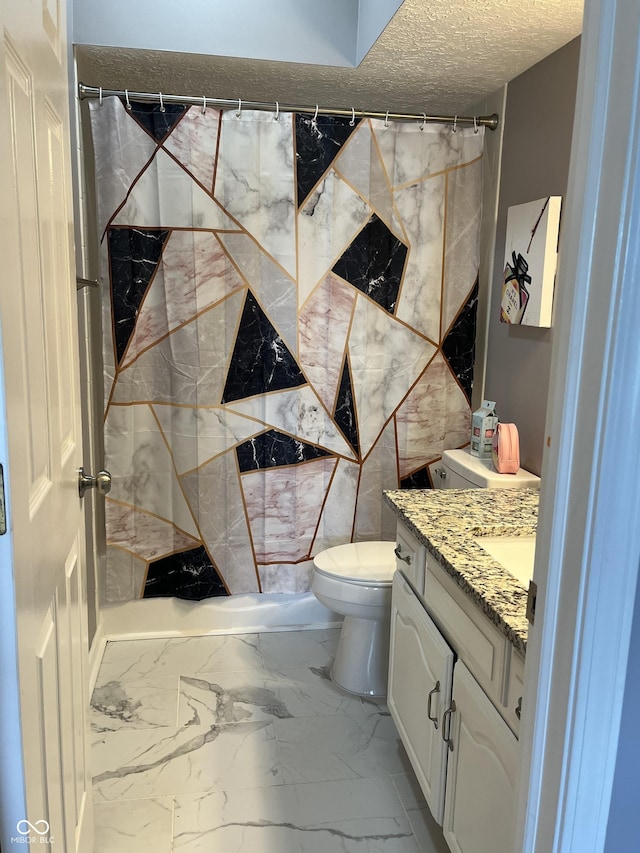7601 Newport Bay Dr Unit 203, Indianapolis, IN 46240 - full bathroom with vanity, marble finish floors, toilet, curtained shower, and a textured ceiling