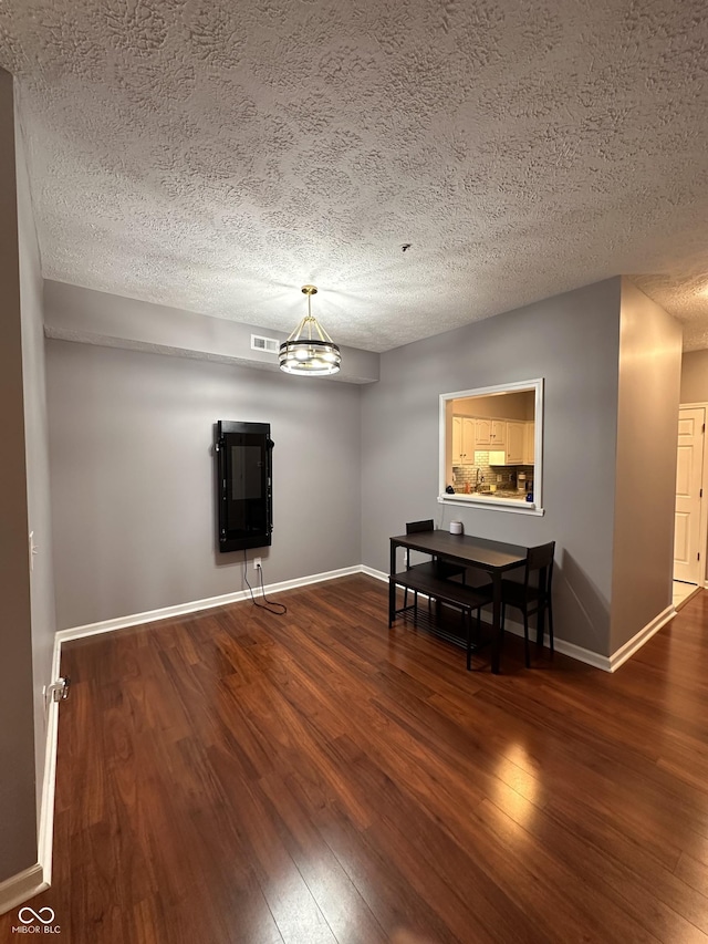 7601 Newport Bay Dr Unit 203, Indianapolis, IN 46240 - dining room featuring wood finished floors, baseboards, and a textured ceiling