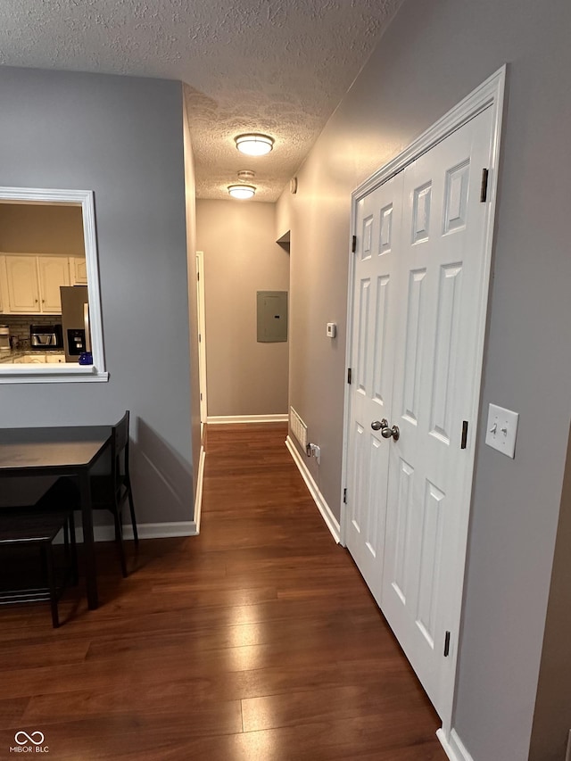 7601 Newport Bay Dr Unit 203, Indianapolis, IN 46240 - corridor with a textured ceiling, dark wood-style floors, electric panel, and baseboards