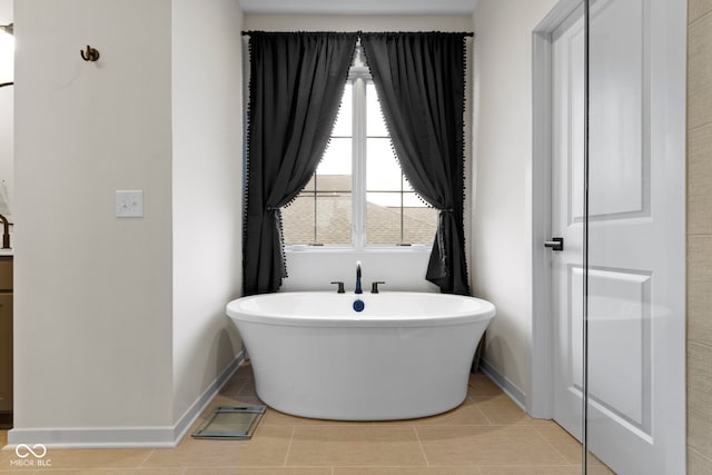 17359 Wilkes Way, Westfield, IN 46074 - bathroom featuring a soaking tub, baseboards, and tile patterned floors