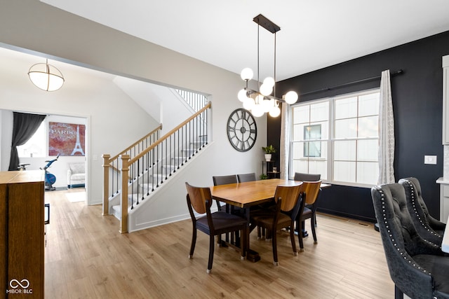17359 Wilkes Way, Westfield, IN 46074 - dining room featuring stairs, light wood-style floors, a chandelier, and baseboards