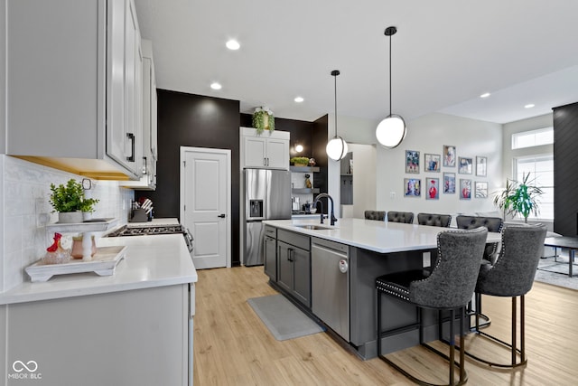 17359 Wilkes Way, Westfield, IN 46074 - kitchen with stainless steel appliances, a sink, decorative backsplash, light countertops, and recessed lighting