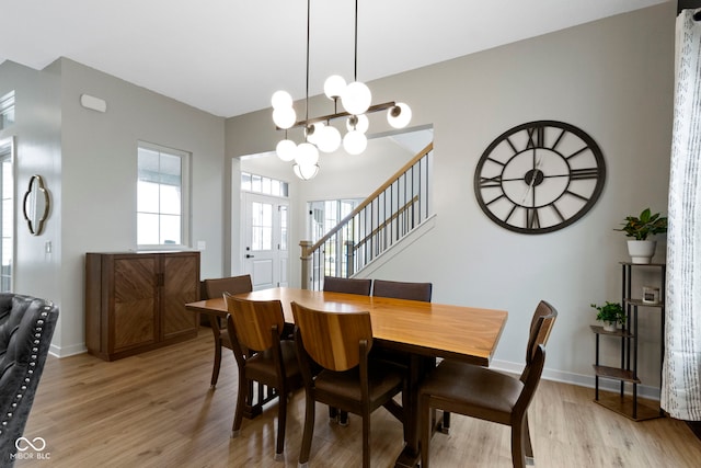 17359 Wilkes Way, Westfield, IN 46074 - dining space with a chandelier, light wood-type flooring, stairway, and baseboards