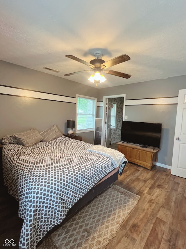 6460 W US Highway 50, North Vernon, IN 47265 - bedroom featuring wood finished floors, ceiling fan, and baseboards