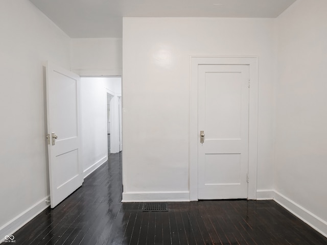 1065 36th St, Indianapolis, IN 46208 - spare room with baseboards and dark wood-style flooring