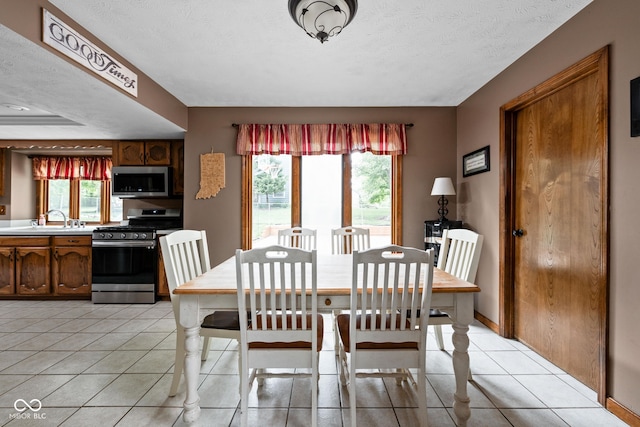 5412 Green Hills Dr, Brownsburg, IN 46112 - dining area featuring light tile patterned floors and plenty of natural light