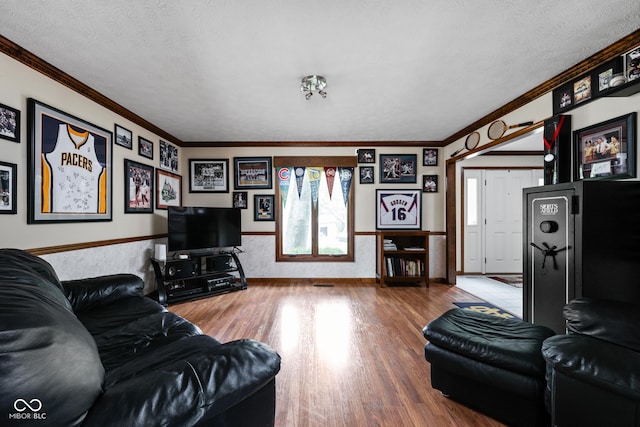 5412 Green Hills Dr, Brownsburg, IN 46112 - living area featuring crown molding, wood finished floors, a textured ceiling, a wainscoted wall, and healthy amount of natural light
