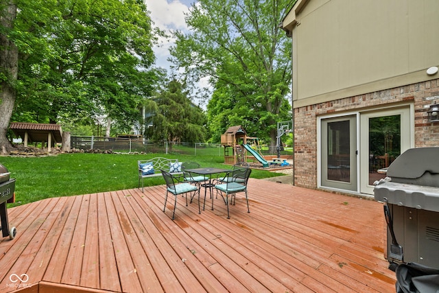 5412 Green Hills Dr, Brownsburg, IN 46112 - deck with a playground, outdoor dining space, a grill, and view of scattered trees