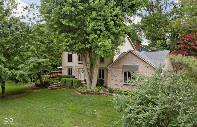 5412 Green Hills Dr, Brownsburg, IN 46112 - view of front of home with a front lawn, a chimney, brick siding, and roof with shingles