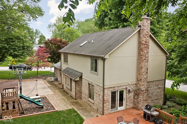 5412 Green Hills Dr, Brownsburg, IN 46112 - back of house with a chimney, a deck, roof with shingles, and brick siding