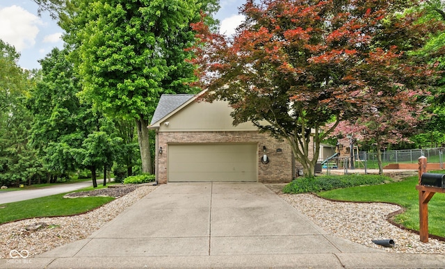 5412 Green Hills Dr, Brownsburg, IN 46112 - view of property hidden behind natural elements featuring brick siding, driveway, and an attached garage