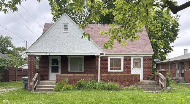 5472 E 10th St, Indianapolis, IN 46219 - view of front of home with a porch and brick siding