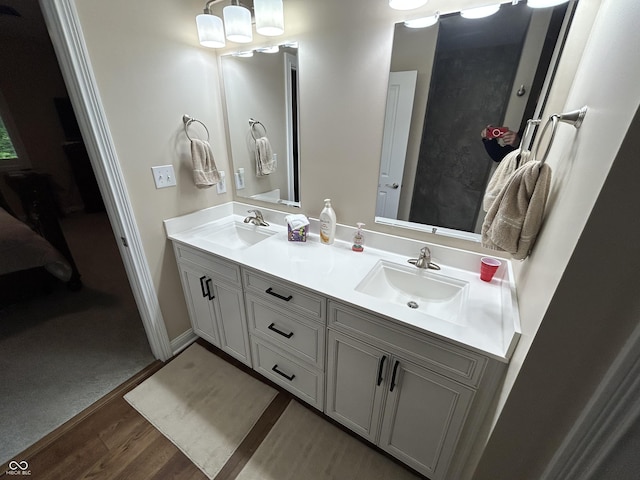 308 Bay Ridge Dr, Pendleton, IN 46064 - full bathroom featuring double vanity, wood finished floors, and baseboards