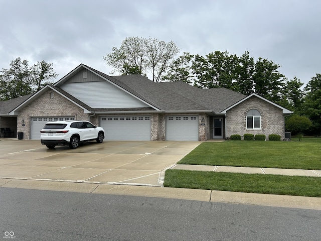 308 Bay Ridge Dr, Pendleton, IN 46064 - view of front of house with an attached garage, brick siding, concrete driveway, a front yard, and roof with shingles