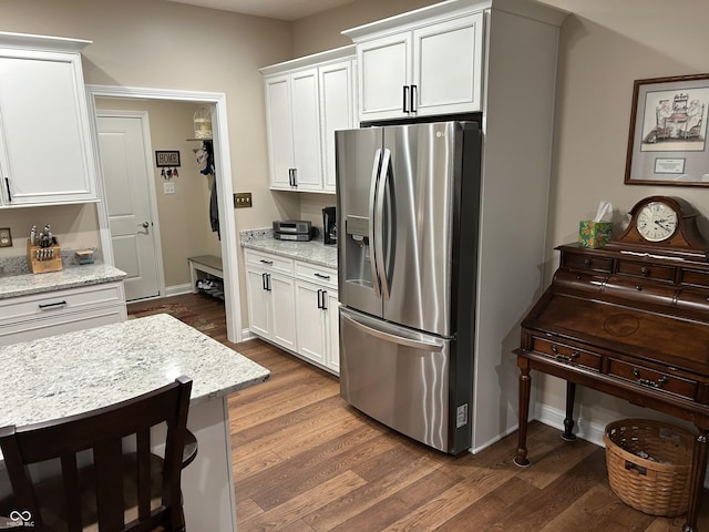 308 Bay Ridge Dr, Pendleton, IN 46064 - kitchen with stainless steel fridge with ice dispenser, white cabinets, dark wood finished floors, and baseboards