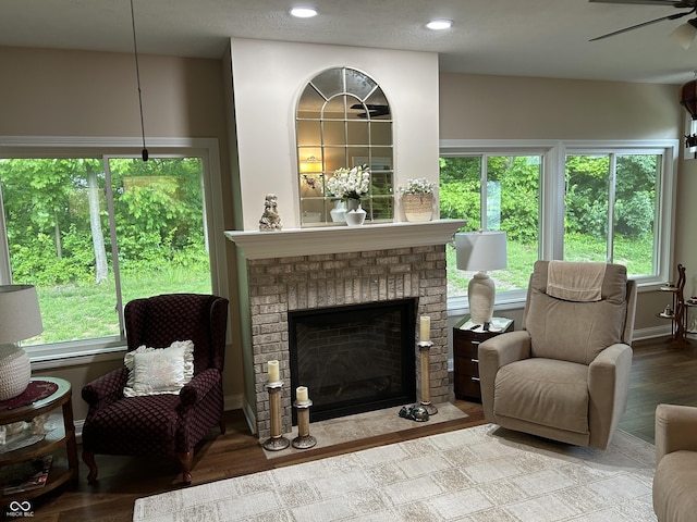 308 Bay Ridge Dr, Pendleton, IN 46064 - living area with a ceiling fan, healthy amount of natural light, wood finished floors, a brick fireplace, and recessed lighting