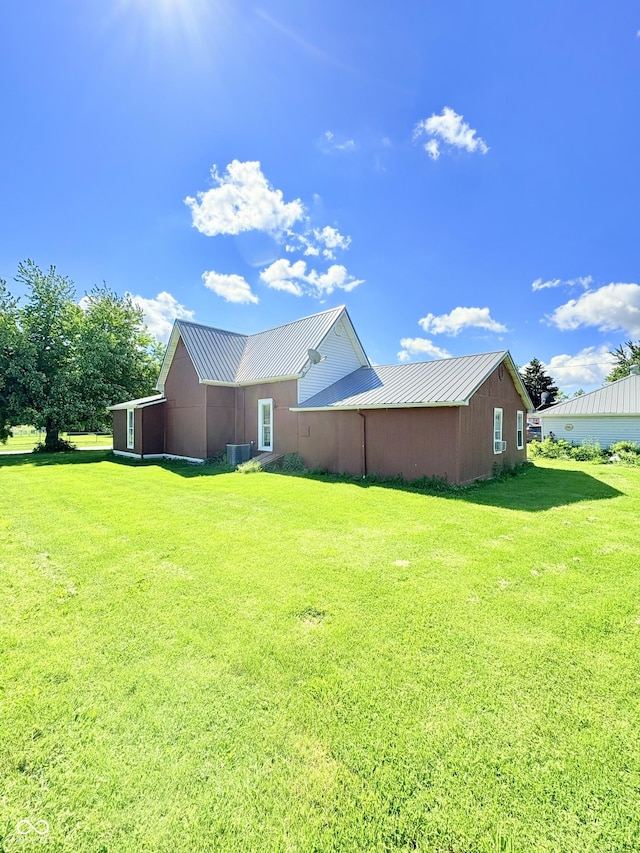 404 S Indiana St, Roachdale, IN 46172 - view of home's exterior with a lawn, metal roof, and central AC unit