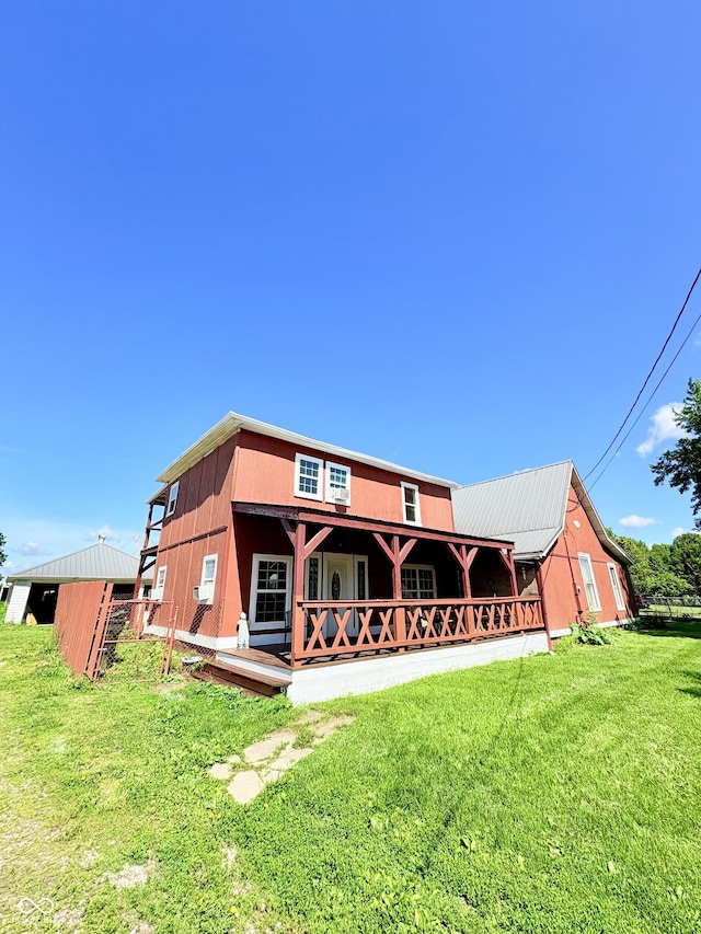 404 S Indiana St, Roachdale, IN 46172 - rear view of property featuring a lawn and covered porch