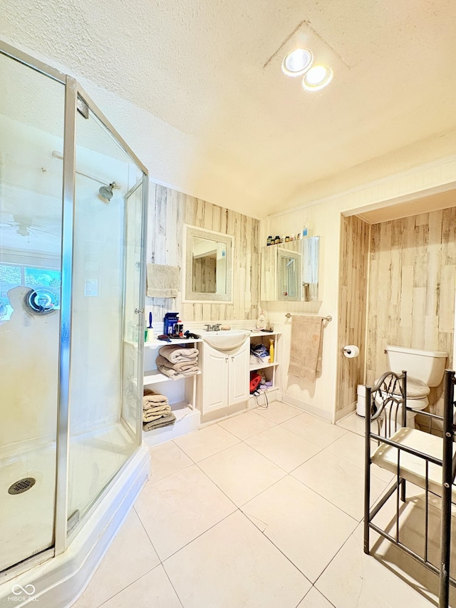 404 S Indiana St, Roachdale, IN 46172 - full bathroom featuring vanity, a shower stall, wooden walls, tile patterned flooring, and a textured ceiling