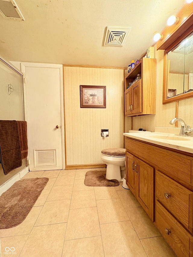 404 S Indiana St, Roachdale, IN 46172 - full bathroom with vanity, a shower stall, tile patterned floors, and toilet