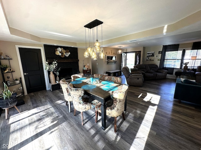 2028 Fairway Dr, Greencastle, IN 46135 - dining room with a fireplace, wood finished floors, and a chandelier