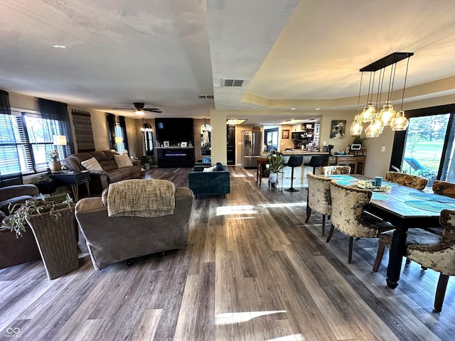 2028 Fairway Dr, Greencastle, IN 46135 - dining room featuring wood finished floors, a raised ceiling, and ceiling fan