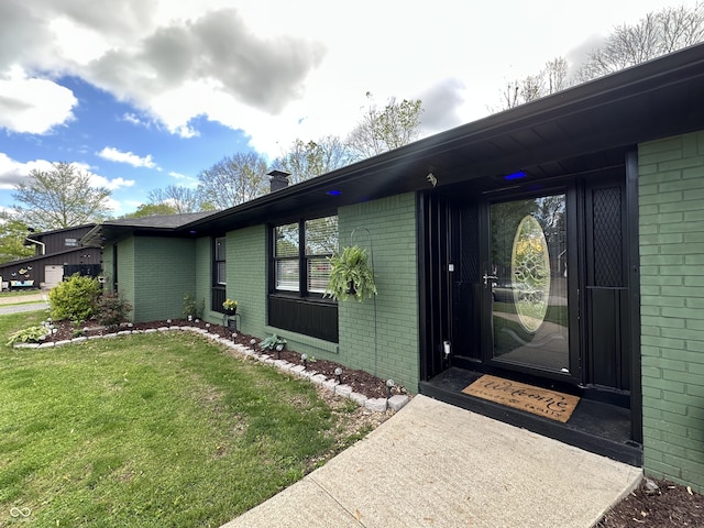 2028 Fairway Dr, Greencastle, IN 46135 - entrance to property featuring brick siding, a lawn, and a chimney