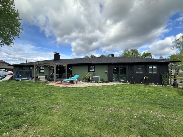 2028 Fairway Dr, Greencastle, IN 46135 - rear view of house with a pergola, a trampoline, and a yard