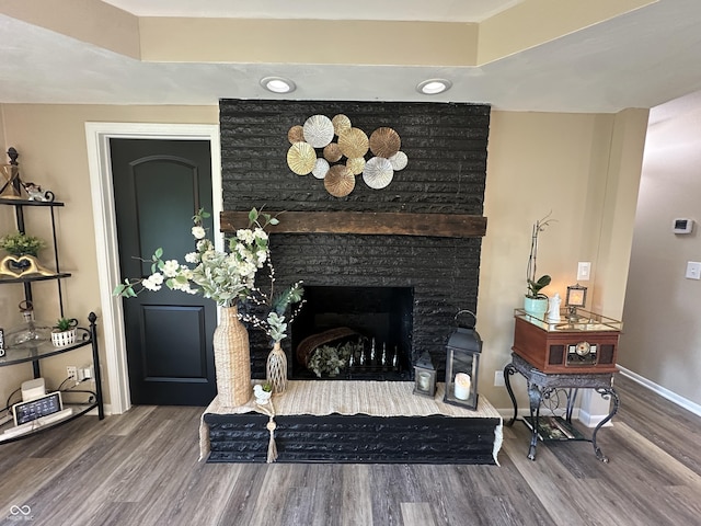 2028 Fairway Dr, Greencastle, IN 46135 - living area featuring wood finished floors, baseboards, and a fireplace with raised hearth