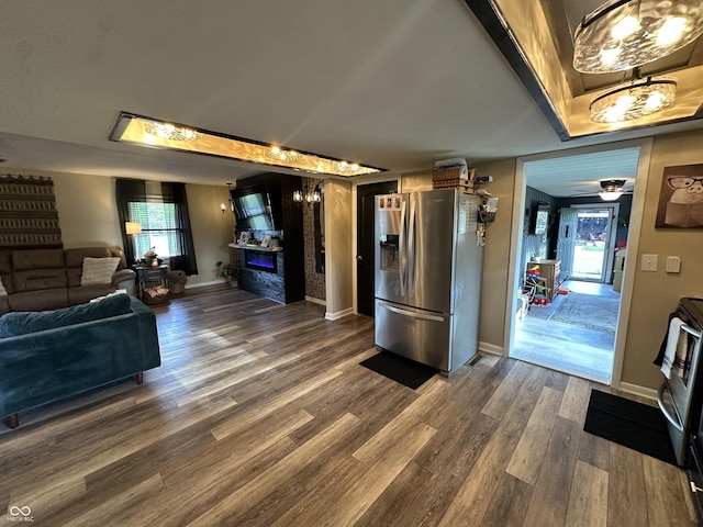 2028 Fairway Dr, Greencastle, IN 46135 - living area with dark wood-style flooring, baseboards, a ceiling fan, and a glass covered fireplace